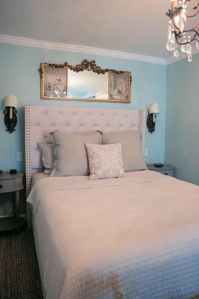 Marseille — the bed made up against a blue-washed wall.